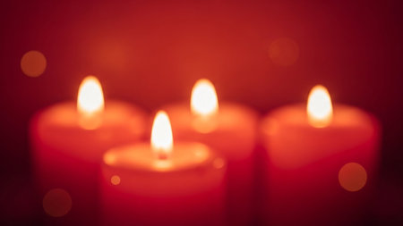 Four red heart-shaped candles glow with soft bokeh lights in a dark setting. Clear details and vibrant colors ...の素材