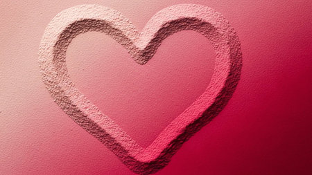 A pink heart shape carved into a textured surface with a soft pink to deep red gradient background.の素材