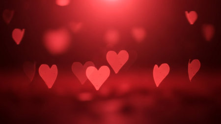 Red heart shaped bokeh lights glowing on a dark, romantic background, creating a soft atmosphere.の素材