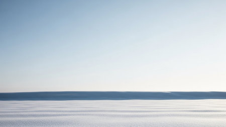 A minimalist winter landscape with a clear blue sky and a vast snowfield with subtle ripple patterns.の素材