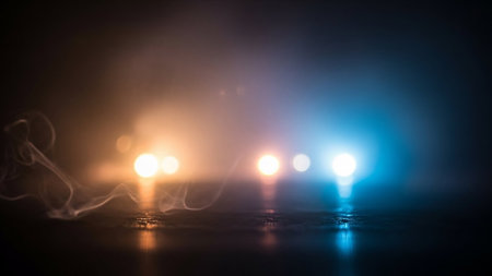 Ethereal smoke wisps drift across a dark surface, illuminated by contrasting soft orange and blue lights, creating a moody and atmospheric scene.の素材