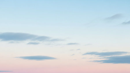 A soft pastel sky with delicate wispy clouds transitioning from pale pink to light blue.の素材