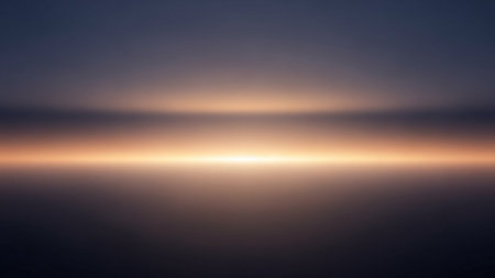 A minimalist abstract image depicting a soft horizon line with a warm, luminous glow, suggesting dawn or dusk over a calm body of water.の素材