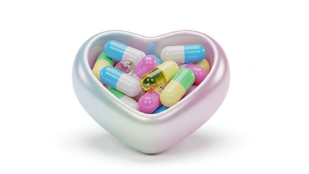 A heart-shaped metallic bowl filled with a variety of colorful pharmaceutical capsules and pills, presented on a white background.の素材