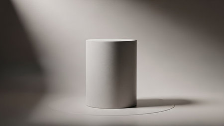 Abstract showing minimalist cylindrical podium with dramatic light and shadow on neutral background keywords: podium, cylinder, pedestal, display,...の素材