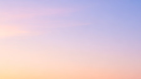 Sunset sky background with tiny clouds, soft pastel colors.の素材