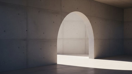 Minimalist concrete interior with an arched doorway casting dramatic light and shadow.の素材