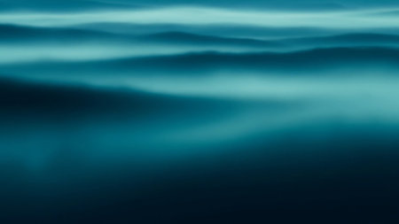 Abstract representation of deep teal and blue ocean waves with a soft focus and an ethereal mist effect, creating a serene and tranquil atmosphere.の素材