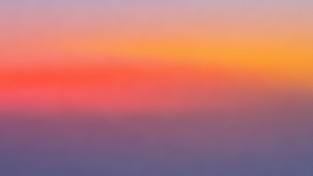 A smooth, soft gradient background transitioning from vibrant coral red and orange to muted purple and pink hues, creating a gentle color blend.の素材