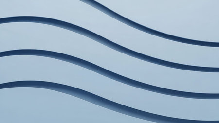 Clean, parallel wavy lines in varying shades of light and dark blue create a minimalist and serene abstract background with subtle depth.の素材