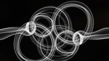Multiple white smoke rings are intertwined in a complex, abstract pattern against a black background.の素材