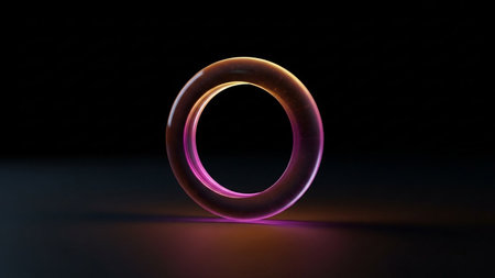 Black showing translucent ring with glowing pink and orange light effects against a dark, moody background with subtle reflections keywords: ring,...の素材