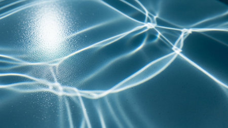 Abstract patterns of light refracted through water surface with bright sun glare Clear details and vibrant col...の素材