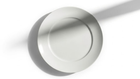 Light showing minimalist white ceramic plate with dramatic shadow and light on a clean white background. resolutionの素材