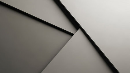 A minimalist abstract composition featuring overlapping geometric planes in varying shades of gray and black, with sharp, defined edges and subtle...の素材