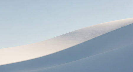 Curved showing minimalist abstract curved sand dune against soft blue sky with subtle shadow play. resolution use.の素材
