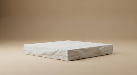 White showing rectangular white stone slab with a rough, natural texture and layered striations resting on a plain beige background with soft studio...の素材