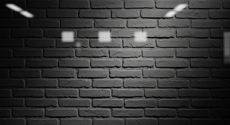 showing dark gray brick wall with bright rectangular light reflections and vignette effect. resolution use.の素材