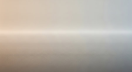 A subtle gradient transitions from warm beige to cool grey with a soft horizontal light band across the middle and a finely textured foreground.の素材