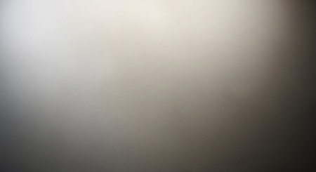 showing softly lit smooth gray wall with subtle gradient and textured surface. resolution use.の素材