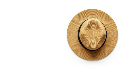A straw fedora hat with a black ribbon is viewed from directly above on a white background.の素材