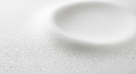 Abstract close-up of a white textured surface with subtle ripples and tiny bubbles.の素材