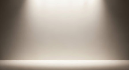 Empty studio background with soft spotlight illumination from above creating a warm gradient effect.の素材