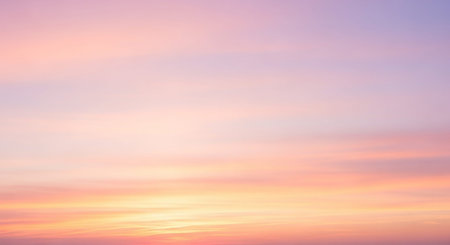 A soft, ethereal sky filled with gentle pastel hues of pink, orange, and lavender, creating a serene and tranquil atmosphere at dawn or dusk.の素材