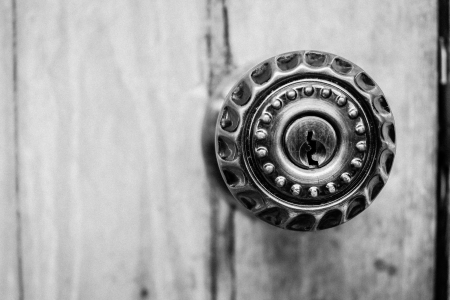 closeup the part of door lock with metal knob on woodの写真素材