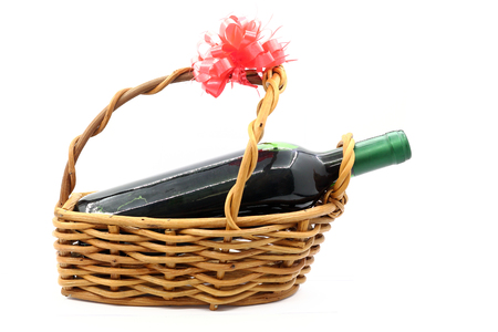 wine bottle isolated in gift basket on white backgroundの写真素材