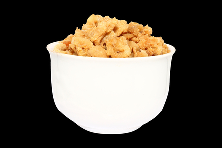 pork crackling in white bowl on isolated backgroundの写真素材
