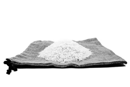 thai raw rice on sack isolated white backgroundの写真素材