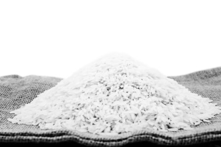 thai raw rice on sack isolated white backgroundの写真素材