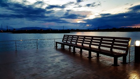 outdoor wood bench with view of river in parkの写真素材