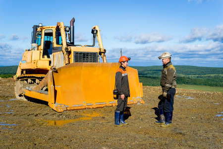 Miners before descending into the mine in front of the bulldozer