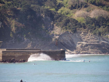 Route to the Gorliz lighthouse, from the beach and between beautiful cliffs. Spain.