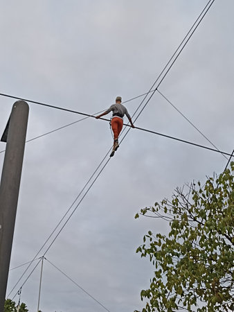 Man balancing on a ropeの写真素材