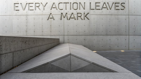 Minimalist concrete architecture with the motivational text: "Every Action Leaves a Mark" creates a powerful visual, perfect for symbolizing lasting impact and design principles.の素材