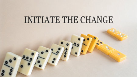 A perfectly aligned row of dominoes begins to fall, illustrating the concept of initiating change and its subsequent chain effect, perfect for presentations on momentum and progress.の素材