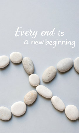 Smooth, light-colored pebbles arranged to form a line of text that reads "Every end is a new beginning", offering a sense of calm and renewal, perfect for inspirational or motivational content.の素材