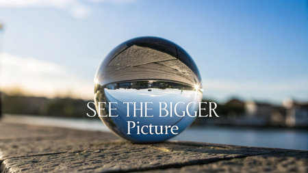 A clear glass sphere perfectly reflects the vast blue sky and a distant landscape on its smooth surface, offering a captivating new perspective, perfect for illustrating concepts of clarity and vision.の素材