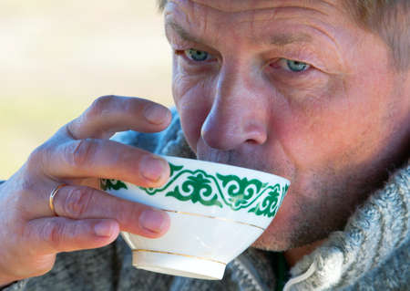 European man drinks tea bowls from the Asianの写真素材