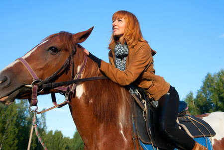 A woman riding a horse in sportの写真素材