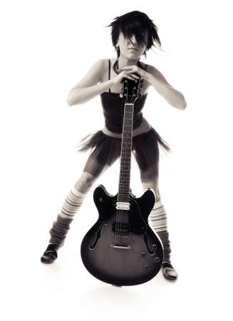 Beautiful girl with a guitar on a black backgroundの写真素材