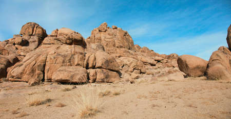 Red rocks in the barren sands of the Gobi Desertの写真素材