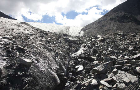 Glacier in the mountains gives rise to the riverの写真素材