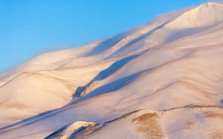 Morning sun in the winter mountainsの写真素材