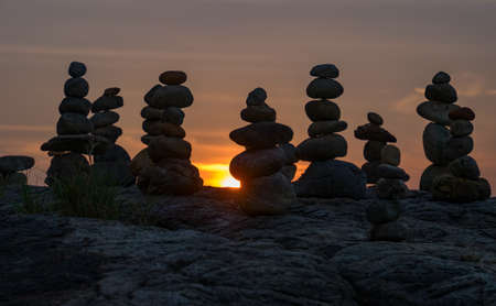 The pyramid of pebbles on the sea shore in the evening