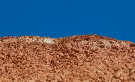 Red earth and blue sky in a wonderful location on the border of Altai and Mongoliaの写真素材