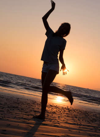 Young woman on the beach in shirtの写真素材